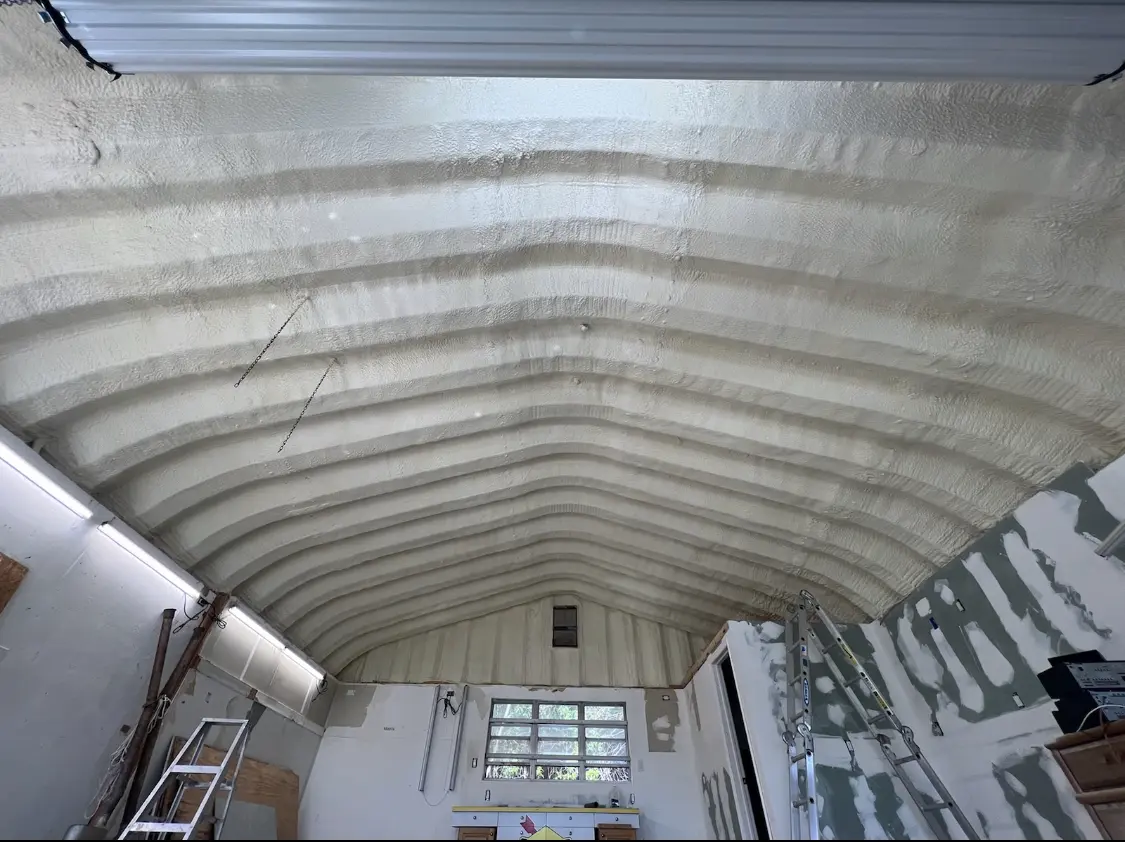 Spray polyurethane foam applied to the underside of a metal roof deck in Norco